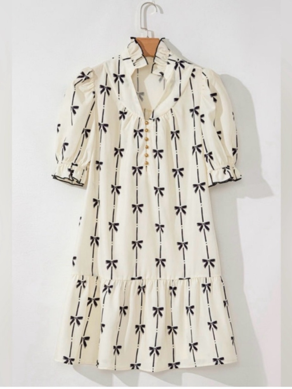 Chic Cream Mini Dress with Black Bow Pattern